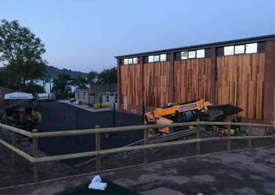 Talocher School construction: excavators and building materials at Monmouth site.