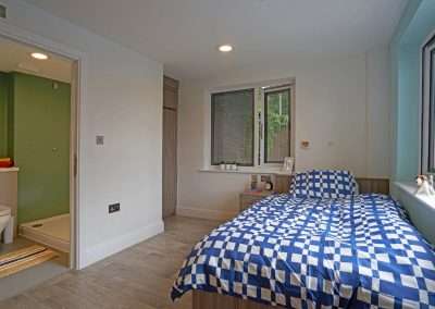 Modern, bright en-suite bedroom interior.