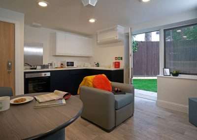 The Lodge at Pinetree Court Hospital: modern kitchen and living area with garden access.