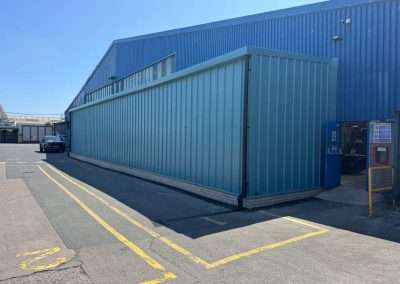 Enersys Cell 2 extension: Teal industrial building extension with loading bay.