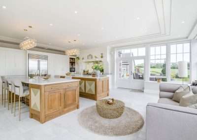 Avarla: Luxurious modern kitchen with island, seating, and sunroom