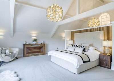 Avarla: Luxurious bedroom with vaulted ceiling, modern bed, and unique lighting.